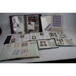 An extensive collection of mint and used stamps in eight albums plus packets.