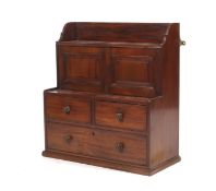 An early 19th century mahogany tiered wall cabinet.