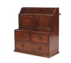 An early 19th century mahogany tiered wall cabinet.