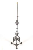 An adjustable standard lamp with a 19th century cast iron base. Photographed height 150cm.