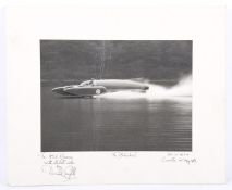 A black and white photograph of 'The Bluebird' signed by Donald Campbell, mounted on white card.