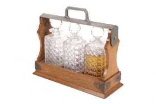 A contemporary tantalus with three cut glass decanters.