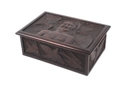 A carved mahogany box. Decorated with a winged angel to the lid and birds to the three side panels.