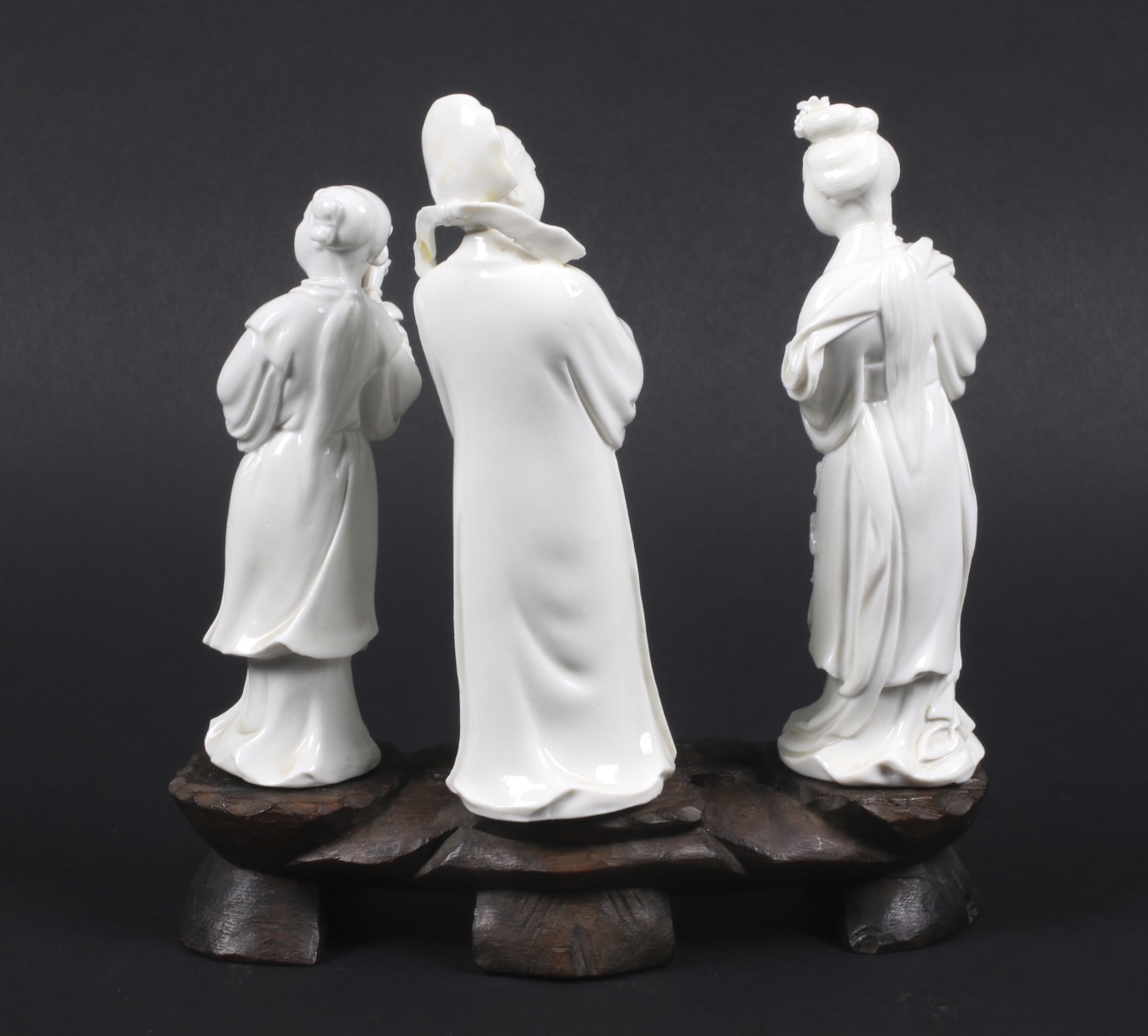 Three Chinese blanc de chine figures mounted on a carved wood base. - Image 2 of 2