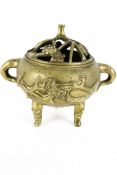 A Chinese 19th century yellow metal lidded censor of squat spherical form.
