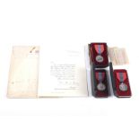 Three boxed Imperial Service Order medallions.