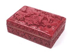 A 20th century Chinese red lacquer style box carved with fo dogs in a garden. H5.5cm x L14.5cm x D9.