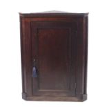 A George III oak corner cupboard containing three shelves. With key. H99cm x W74.5cm x D42.