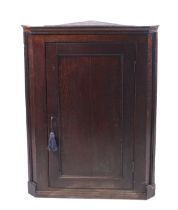 A George III oak corner cupboard containing three shelves. With key. H99cm x W74.5cm x D42.