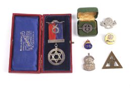 A boxed silver order Buffalo medal and other badges.