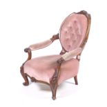 A Victorian carved walnut open armchair.