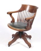 An early 20th century oak swivel tilt adjustable office chair.