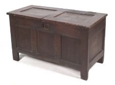 An 18th century and later oak coffer. With inset panels and hinged cover. H60.5cm x W109cm x D49cm.