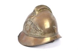 A vintage French brass fire helmet marked Sapeurs pompiers de bresseux with original leather lining.