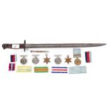 Three WWII medals, 1939-45, two further medals and a bayonet.
