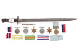Three WWII medals, 1939-45, two further medals and a bayonet.