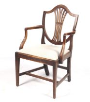 An early 20th century mahogany armchair with shield back and upholstered seat. H95cm.