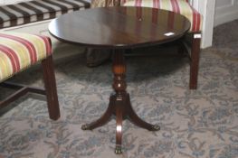 A 20th century mahogany small drop flap circular table. Four legs. 56cm H and 61cm diameter.