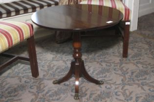 A 20th century mahogany small drop flap circular table. Four legs. 56cm H and 61cm diameter.