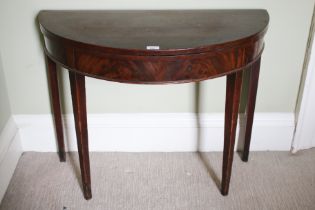 An 18th century mahogany demi-lune card table with four legs, two hinged verso, 72cm H,
