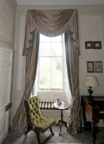 A pair of damask silk lined curtains and matching tasselled pelmet.