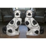 A pair of black and white Staffordshire type spaniels. Measuring 28 cm high.