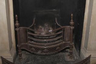 A Regency manner serpentine shaped cast iron and steel fire basket. Flanked with turned finials, 66.