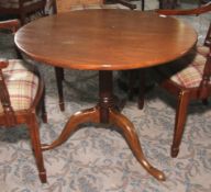 An early 19th century mahogany four legged pedestal breakfast table.