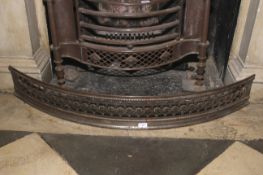 A late Georgian steel bowed fire fender. Pierced roundel decoration, 17.5 cm H x 119 cm W.