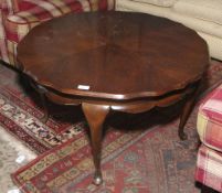 A 20th century mahogany circular shaped four leg coffee table.