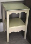 A pair of 20th century painted two tier bedside tables, each 64cm H, 40cm W, 40cm D,