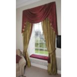 A pair of lined curtains with tasseled pelmet.