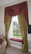 A pair of lined curtains with tasseled pelmet.