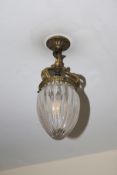 An early to mid 20th century glass and brass bullet shaped pendant ceiling light