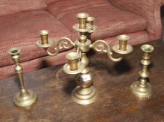 A 20th century four branch candelabra and two associated brass candlesticks.