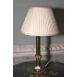 A contemporary brass table lamp.