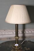 A contemporary brass table lamp.