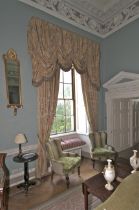 A pair of damask silk lined curtains and matching tasselled pelmet.