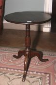 A 19th century stained oak circular top pedestal tripod table. 66cm H, 54cm diameter.