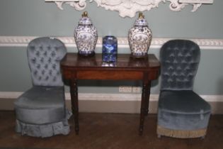 A pair of early 20th century style, blue velvet button back boudoir chairs.