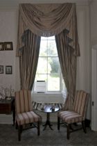 A pair of damask silk lined curtains and matching tasselled pelmet.