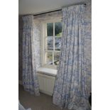 A pair of lined cotton curtains. Printed in blue and white with countryside scenes.