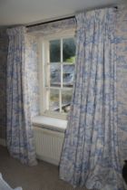 A pair of lined cotton curtains. Printed in blue and white with countryside scenes.