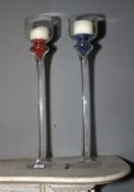 A pair of contemporary tall glass candlesticks.