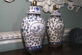 A pair of Chinese blue and white vases. On stands with lion finials to lid, 44cm H.