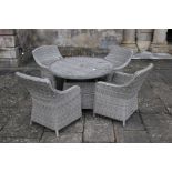 A set of rattan garden furniture comprising table and four chairs