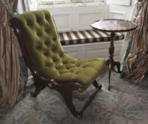 A 20th century mahogany piecrust tripod table and a green velvet button back slipper chair.