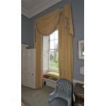 A pair of lined curtains with tassled pelmet.