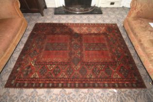 An early 20th century machine made woollen rug.