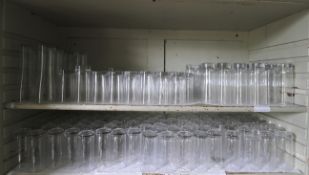 A large assortment of glassware to include high ball tumblers, lager glasses etc. Approximately 130.